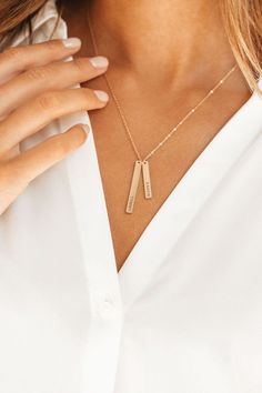 Stylish, dainty, and adorable! Our cute double bar necklace looks perfect on anyone. Thanks to its sleek, sophisticated, and simple design. You can engrave any name, word, date, or phrase you want on these bars. Popular choices include name, initials with a memorial date. Choose from Gold, Silver or Rose gold finish to get an excellent gift for anyone on your list or yourself. #customizednecklace #necklace #necklaceforher #customnecklace #necklaceforwomen Gold Bar Necklace Engraved, Personalized Engraved Jewelry, Engraved Bar Necklace, Vertical Bar Necklace, Silver Bar Necklace, Name Initials, Gold Bar Necklace, Mom Jewelry, Engraved Jewelry