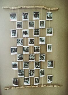 a bunch of pictures hanging on a wall with clothes pins attached to the pegs