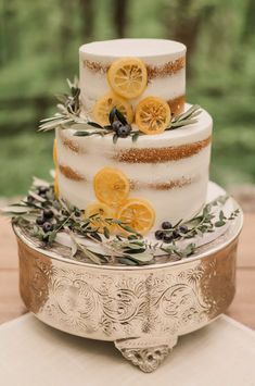 a three tiered cake with lemon slices on top