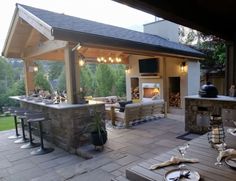 an outdoor kitchen and dining area is shown