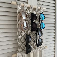 several pairs of sunglasses hanging on a wall