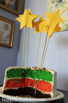 there is a cake that has been decorated with stars and colors on the icing