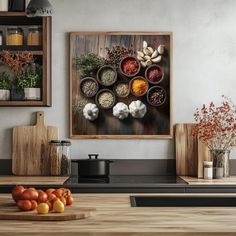 a kitchen with an art work on the wall and various vegetables in bowls sitting on the counter