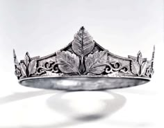 a silver crown ring with leaves on the front and sides, set against a white background