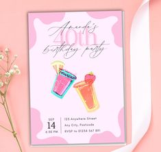 a pink birthday card with two cocktails and strawberries on it next to flowers