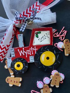 a tractor ornament decorated with gingerbreads and candy canes