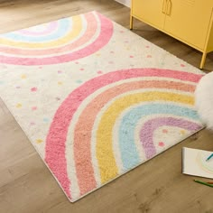 a child's room with a rug, crayons and pencils on the floor