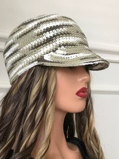 a mannequin head wearing a hat with sequins on the brim