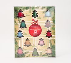 a card with twelve different colored christmas trees on it and a red ribbon hanging from the top