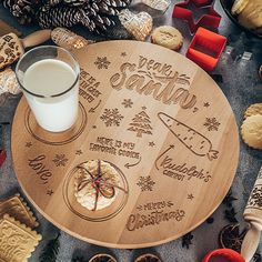 a wooden table topped with cookies next to a glass of milk