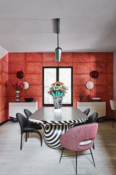 the dining room is decorated in pink and black