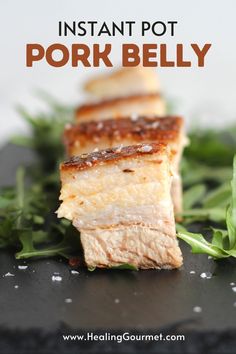 some food that is sitting on top of a black plate with the words instant pot pork belly