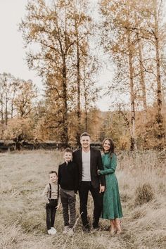 a family poses for a photo in an open field