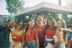 a group of young people standing next to each other in front of a food truck