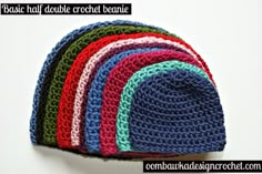 there is a crochet beanie on top of the other hat in different colors