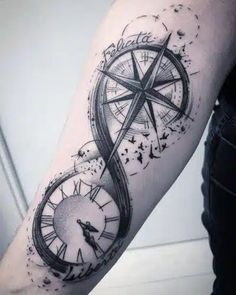 a man with a compass tattoo on his arm