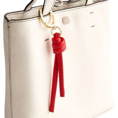 Add a touch of flair to your bag or backpack with our Every Day Bag Charm. Designed to elevate your accessory game, this stylish charm features a stylized tassel that adds a playful and sophisticated touch to any bag, making it the perfect accessory to express your unique sense of style. Vera Bradley Every Day Bag Charm Keychain in Red Elegant Everyday Bag Charm With Logo, Logo Charm Bag For Everyday Use, Everyday Bag Charm With Lobster Clasp, Chic Bags With Logo Charm For Everyday, Trendy Bag Charm As A Gift, Elegant Bag Charm For Everyday Use, Rectangular Logo Bag Charm, Trendy Bag Charm Keychain For Everyday Use, Trendy Bag Charm For Everyday Use