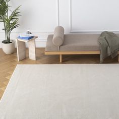 a white rug sitting on top of a wooden floor