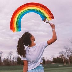 a woman holding a rainbow shaped kite in her hand with the caption for a single heartbeat, as she passed our eyes met cuz sometimes girls who look straight aren't