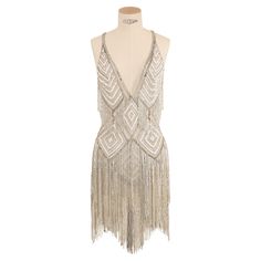 LOVE LALI VINTAGE An incredibly rare dress from Zuhair Murad Haute Couture Fall 2006 This really is a work of art, a tasseled flapper style mini dress. The dress is sheer mesh and is completely covered in white, gold and silver beads and silver and sheer iridescent sequins. It has a low cut plunging neckline, and a completely backless cut with straps that cross over the back. The dress itself is composed of a white stretch body suit (please see the photos) and the tassels start to fall from the Zuhair Murad White Dress, Zuhair Murad Egyptian Collection, Zuhair Murad Backstage, Zuhair Murad Ancient Egypt, Zuhair Murad 2022 Couture, Rare Dress, Zuhair Murad Haute Couture, Flapper Style, Sequin Mini