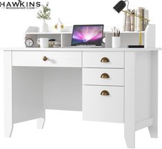 a white desk with a laptop on it and other office supplies in front of it