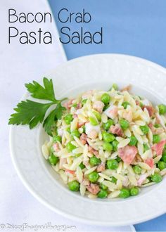 a white bowl filled with pasta and peas