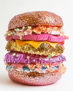 a large hamburger covered in lots of different colored confetti and tinsels