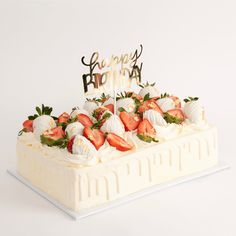 a birthday cake with strawberries on top