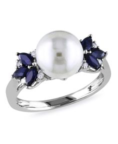 This beautiful ring is crafted in lustrous white gold and features a round cultured freshwater pearl and 6 marquise-cut (4x2mm) sapphire gemstone with 8 round icy diamond accents. The ring is enhanced with a high polish finish. Diamond And Sapphire Ring, Traditional Engagement Rings, Gold Cocktail Ring, Gold Cocktail, Freshwater Cultured Pearls, Pearl Diamond, Pearl Ring, Cultured Pearls, Bling Bling