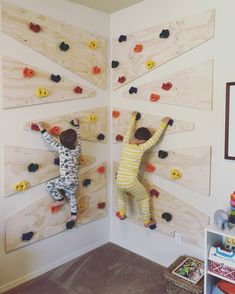 two children climbing on wooden boards in a room