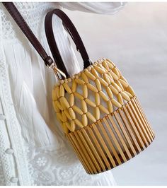 Unlock your inner elegance with the Elena Handbags Summer Bamboo Bucket Shoulder Purse. Expertly hand-woven from quality bamboo, this luxury Bucket Bag is the perfect accessory for any stylish occasion, from the office to a formal event. With its timeless design, it's sure to become your new favorite. Enjoy maximum convenience and beautiful aesthetics with this exquisite bag. Size: 18cm tall x 15cm wide (7in x 6in) Designer Style ID: 8476 Women's Bamboo Bucket Bag, Hand Woven Bucket Bag, Fashion Sustainable Bag, Bamboo Bag, Bohemian Bags, Crochet Clutch, Woman Weaving, Luxury Designer Handbags, Designer Style, Woven Bag, Lv Bag