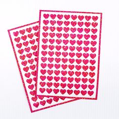 two red hearts stickers on top of each other