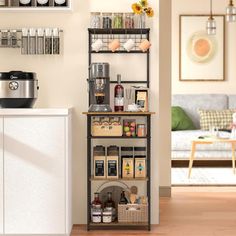 a kitchen area with shelves, coffee maker and other items on the counter top in front of a couch