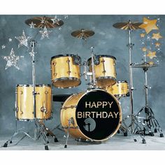 a drum set with happy birthday written on the front, and stars in the background