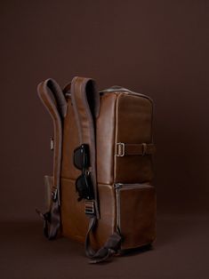 a brown piece of luggage sitting on top of a table