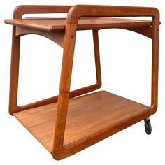 a wooden serving cart with wheels on the front and back sides, designed to look like a modern design