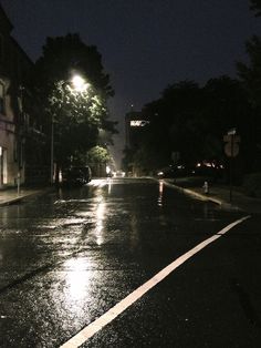 an empty street at night in the rain