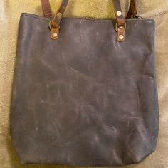 New Without Tags. In Blue Brand Small Leather Tote, Zip Closure. Bag Is In The Color ‘Wolf’ Which Is A Dark Gray. Bag Measures 10 In Tall, 9 In Wide At The Top, 7 In Wide At The Bottom, 3 In Deep. Strap Drop Is 12 In. Inside Is Natural Raw Leather. One Slip Picked And Small Leash Loop. Leather Variations Is Natural To The Leather. Raw Leather, Bags Leather Handbags, Leather Handbags Tote, Small Tote, Blue Bags, Leather Handbag, Blue Leather, Michael Kors Monogram, Womens Tote Bags