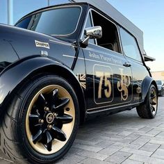 an old black car with gold lettering on it