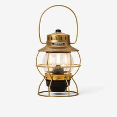 an old fashioned lantern with its light on it's side, against a white background