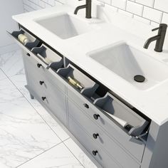 two sinks in a bathroom with marble counter tops and white tiles on the wall behind them