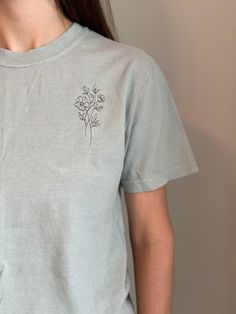 Embroidered Floral Tshirt  Color: Bay  Thread Color: Moss Green  Material: 100% Cotton  Sizing: Unisex  Embroidery Details: Floral design placed on the left of the chest  Follow along on Instagram! @greenerthreads_ Floral Tshirt, Comfort Colors Tshirt, Scrub Pants, Embroidered Tshirt, Beautiful Embroidery, Embroidery Details, Work Attire, Moss Green, Tshirt Colors