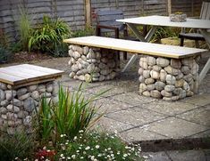 an outdoor table and bench made out of rocks with the words rocky landscaping ideas above it