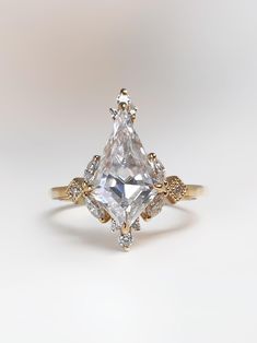 an engagement ring with a large white and yellow diamond in the center, surrounded by smaller diamonds