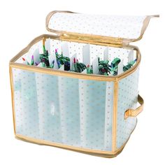 an open suitcase filled with toothbrushes on top of a white table next to a wall