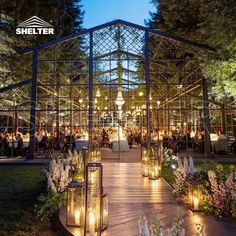 an outdoor venue with candles lit up at night