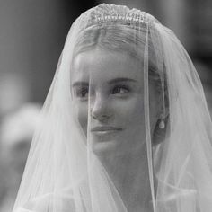 black and white photograph of a woman wearing a wedding veil with pearls on her head