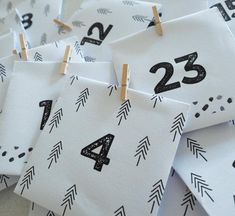 small black and white numbers are hung on clothes pins