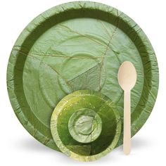 a green paper plate with a fork and spoon