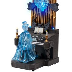 an organ with blue lights on it and a wizard figurine next to it